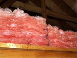 A thick layer of fiberglass insulation in an attic.