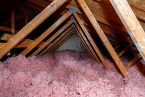 Attic space filled with blown-in pink insulation